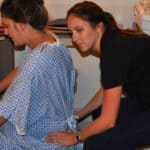 Buddha Belly Doula providing back massage at hospital birth in Tampa, FL
