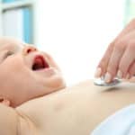 Pediatrician doing baby wellness exam