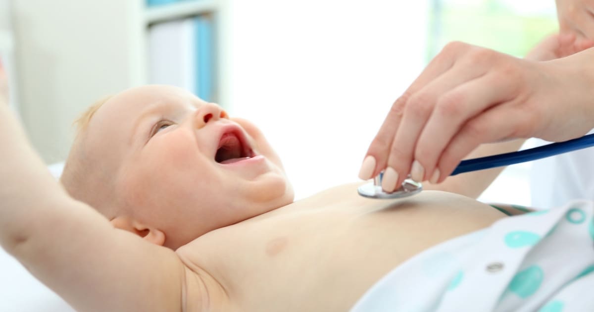 Pediatrician doing baby wellness exam