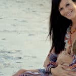 Breastfeeding mom on beach