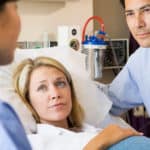 pregnant couple consulting doctor at hospital