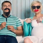 pregnant couple with masks