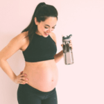 pregnant mom after workout, drinking water