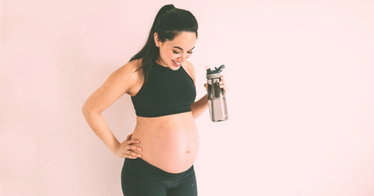 pregnant mom after workout, drinking water