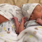 twin newborns with pacifiers