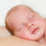 newborn baby skin to skin with parent