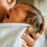 dad holding crying baby
