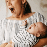 new mom and baby yawning together in nursery