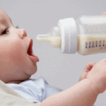 infant being fed with bottle