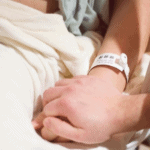 partner holding moms hand in hospital during birth