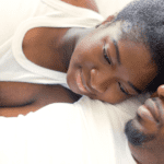 postpartum couple snuggling and breastfeeding