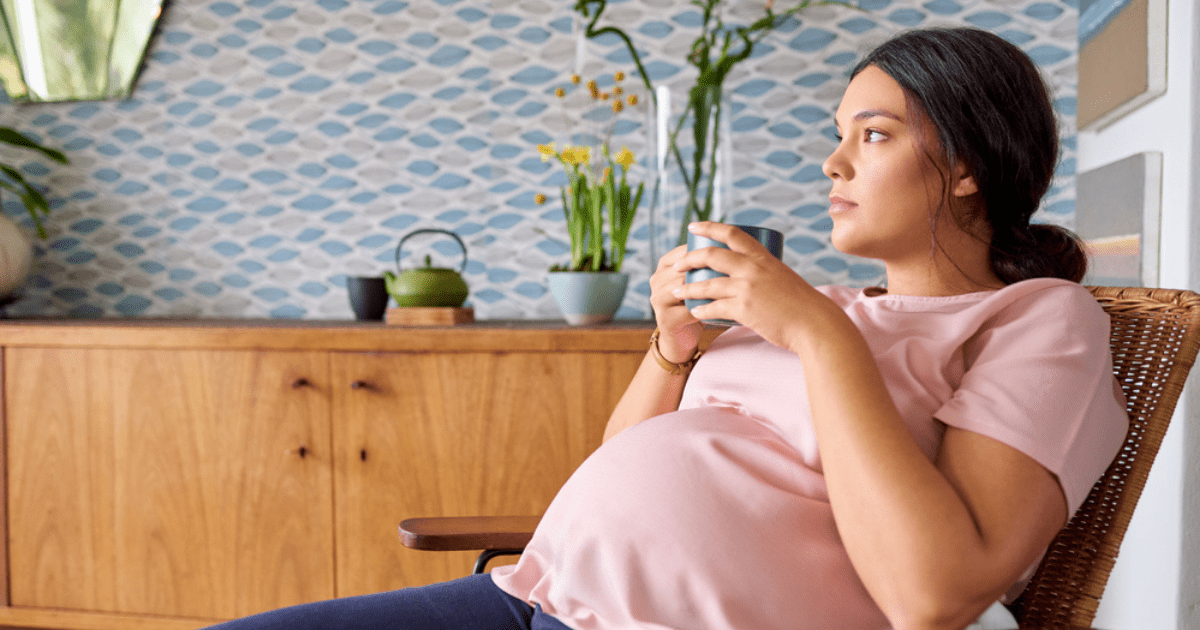pregnant mom thinking in chair