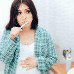 pregnant woman brushing teeth