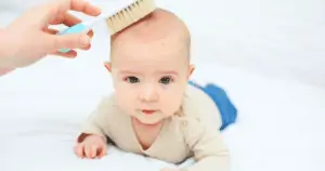 brushing baby hair with soft brush cradle cap