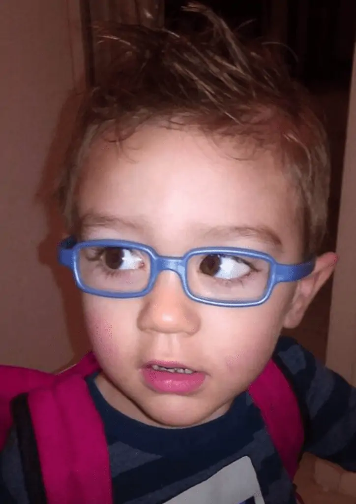 toddler wearing glasses, cross-eyed