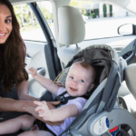 new mom practicing car seat safety with baby in care seat