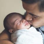 new dad kissing baby