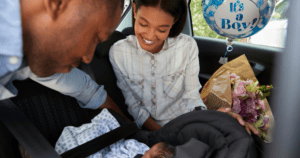 Bringing Baby Home, new parents in the car putting baby in car seat