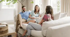Birth Doulas Meeting with a Pregnant Couple sitting on a couch