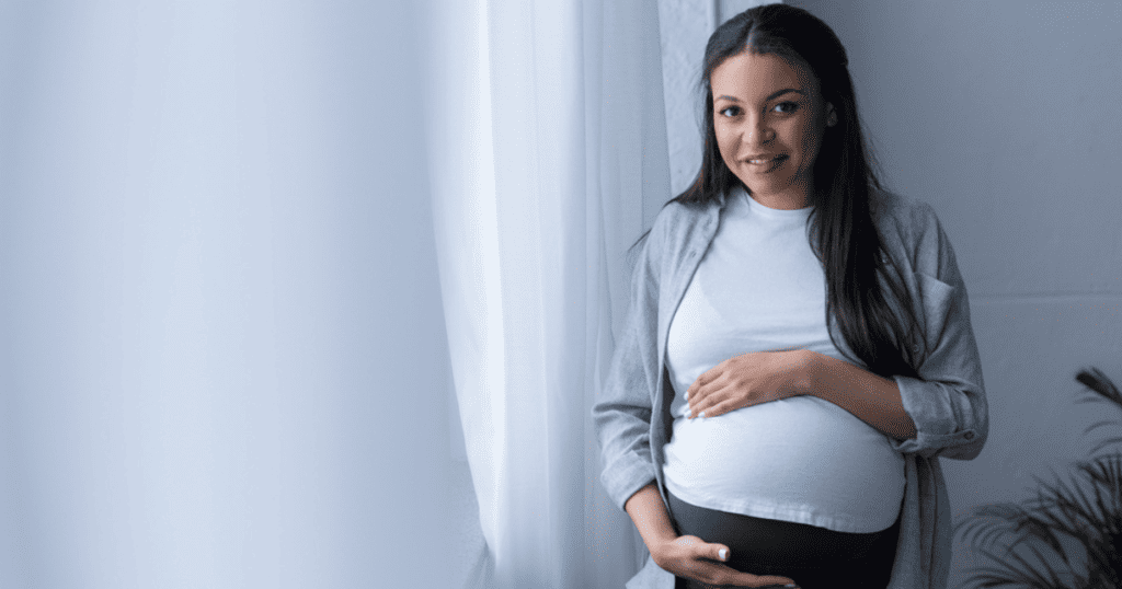 Pregnant Mother holds belly