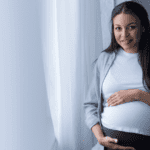 Pregnant Mother holds belly