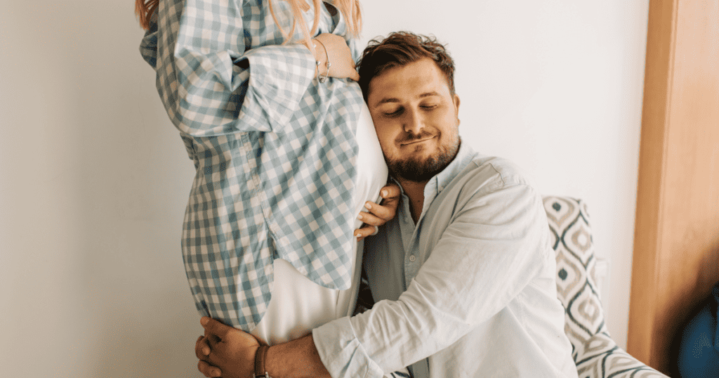 dad hugging pregnant partner