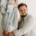 dad hugging pregnant partner