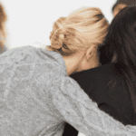 Woman embracing another women in a therapy group