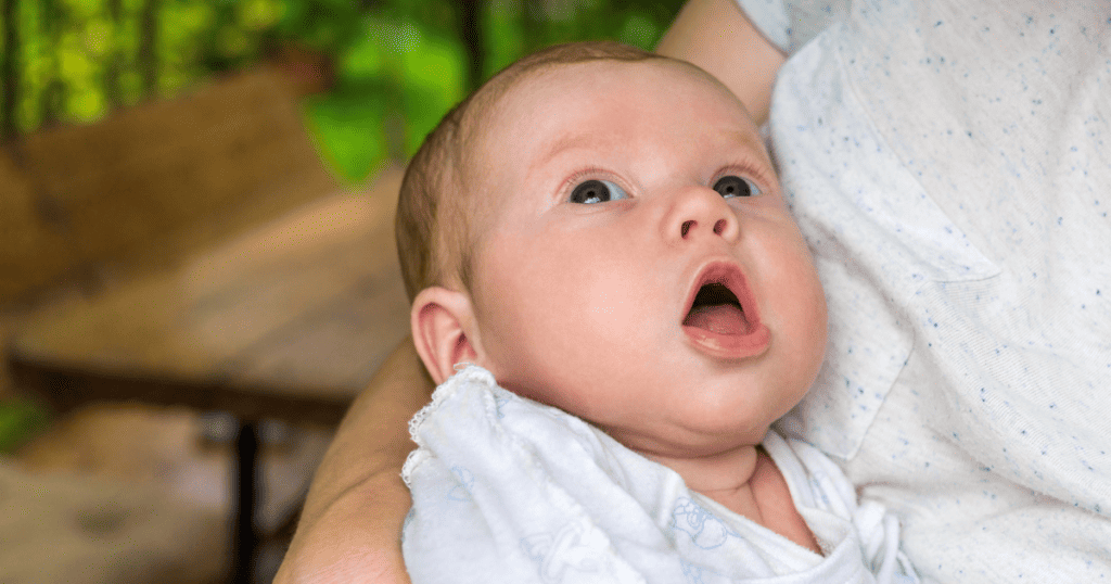 Baby with mouth open showing she is hungry