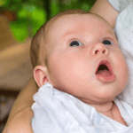 Baby with mouth open showing she is hungry