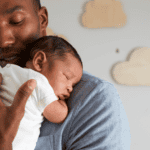 Dad holding newborn baby sleeping