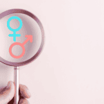 magnifying glass looking at boy or girl symbols