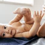 mom putting ointment on baby bottom as diaper rash treatment