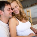 Pregnant Mom and husband snuggling during pregnancy