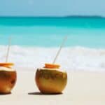 Coconuts on beach with straws