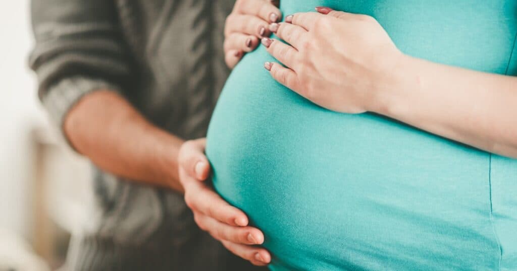 maternal bonding, hands on pregnant belly