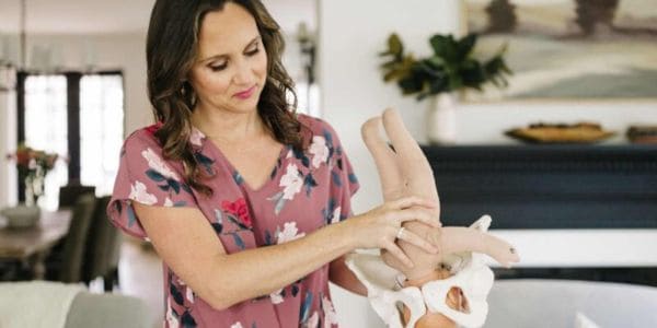 Owner of Buddha Belly Doulas Christie Rinder teaches birth class with baby model and pelvis