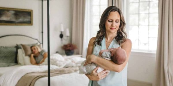 postpartum doula christie rinder holds a baby. She is the founder of Buddha Belly Doulas in Tampa Florida