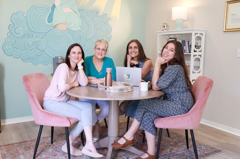 Buddha Belly Doulas Team members at table smiling