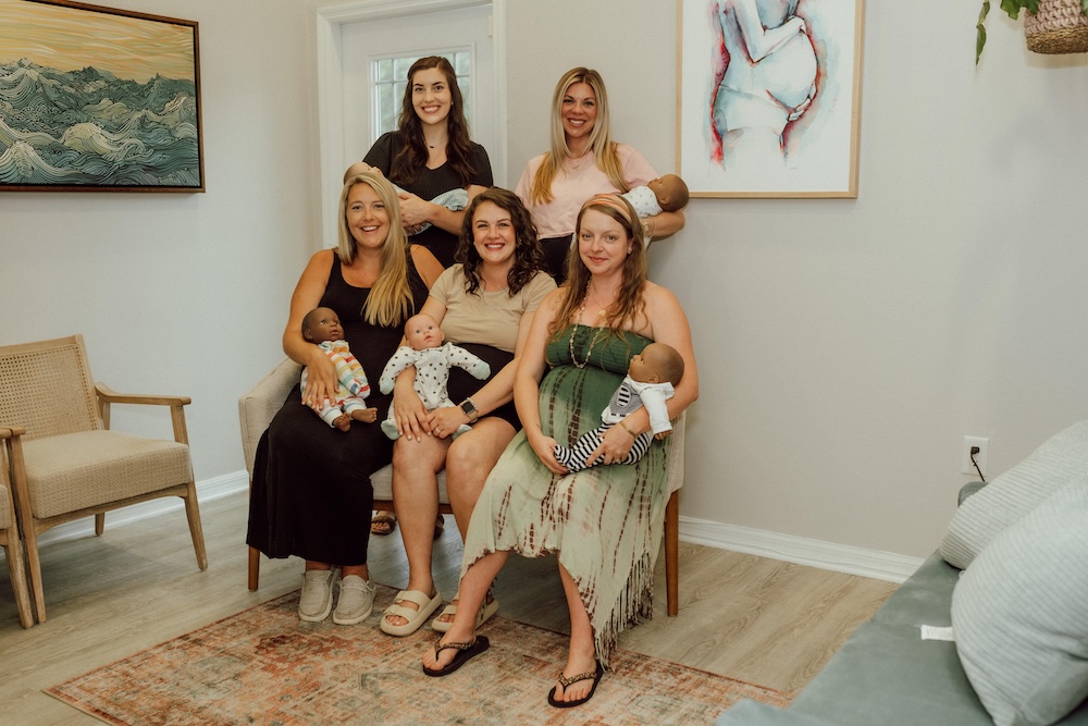 Group of women at buddha belly doulas tampa center after taking a newborn care class.