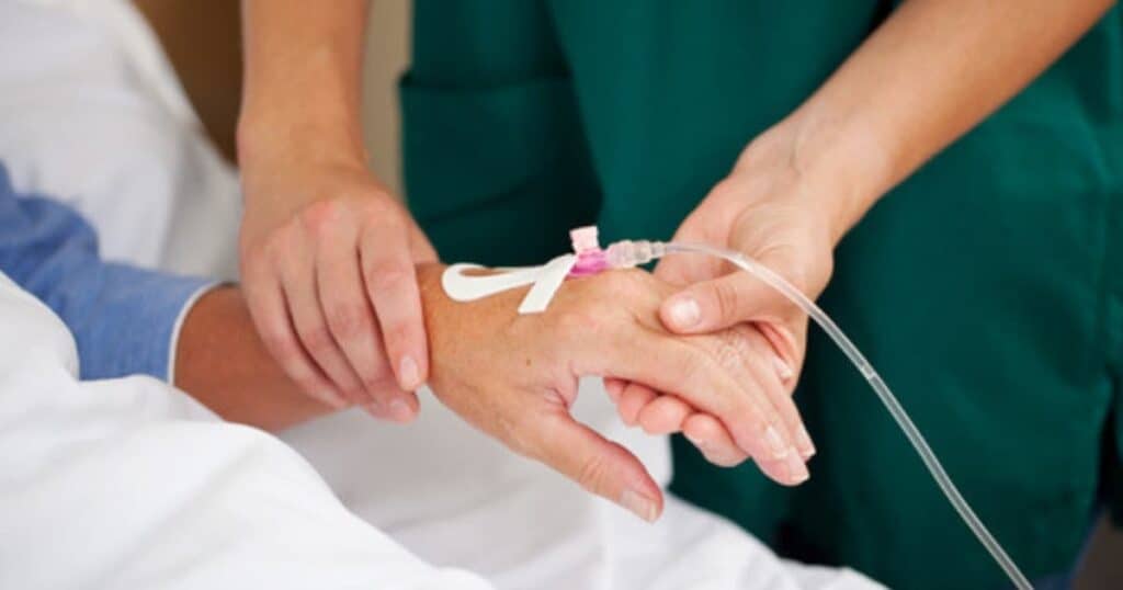 hospital labor induction with iv in patient's hand held by nurse