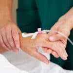 hospital labor induction with iv in patient's hand held by nurse
