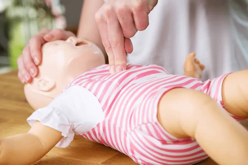 hands on practice in a Tampa Bay infant cpr class using infant doll