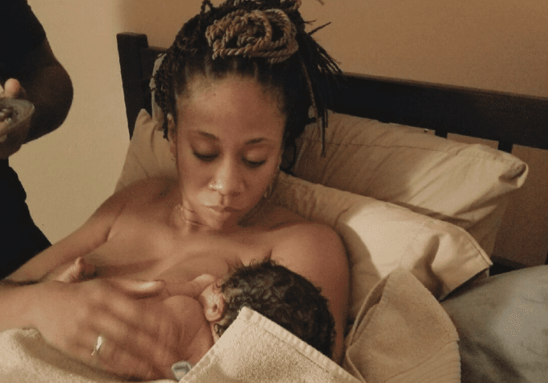 Black Mom Breastfeeding newborn baby at home