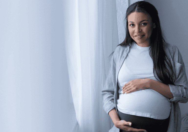 Pregnant Mother holds belly