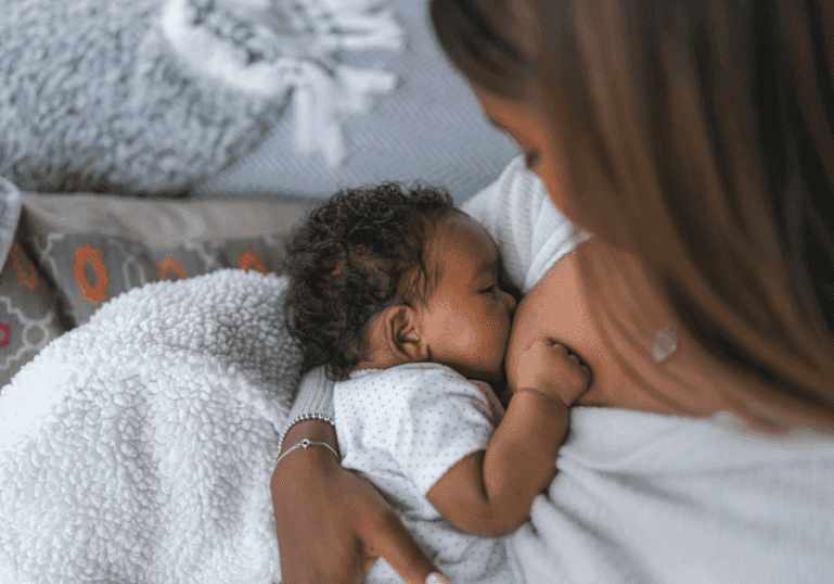 newborn baby breastfeeding at home