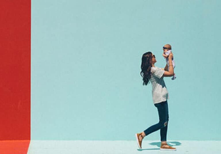 new mom holding baby walking