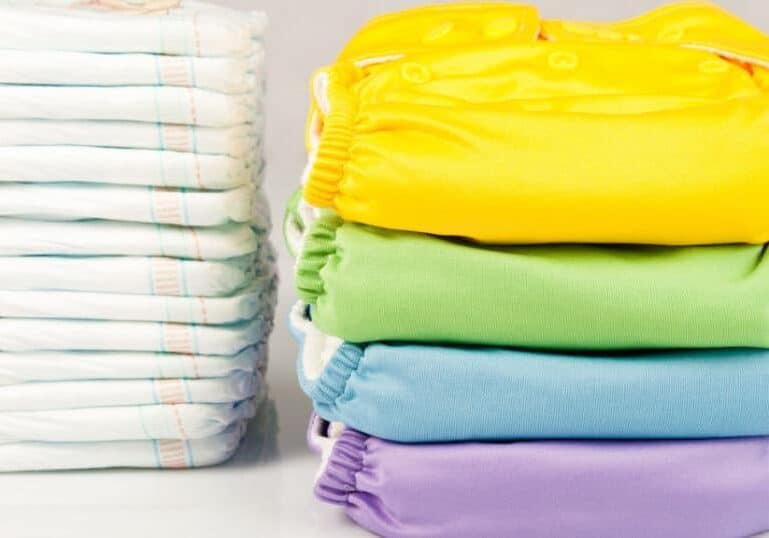cloth and disposable baby diapers in stacks