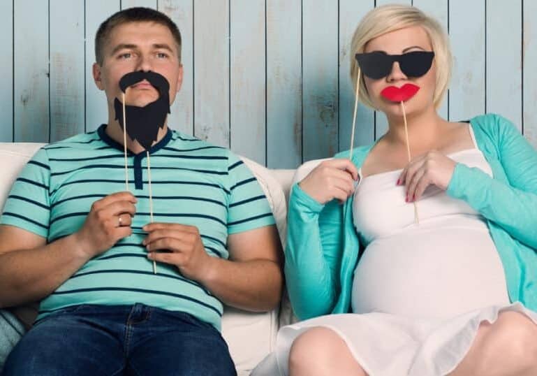 pregnant couple with masks