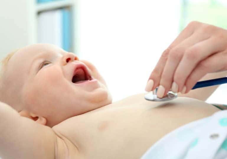 Pediatrician doing baby wellness exam